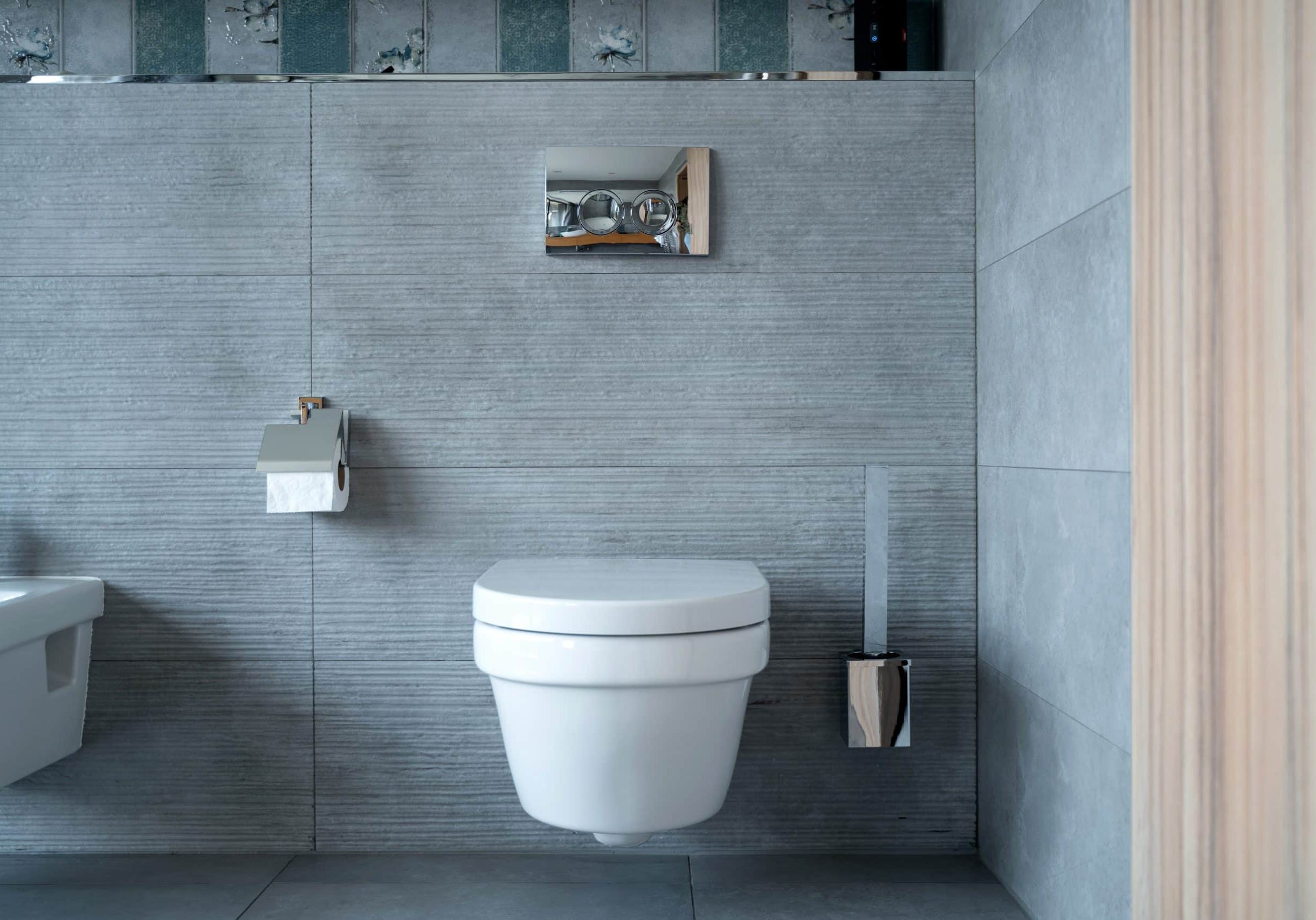 Large toilet room with modern plumbing fixture Front view of a spacious toilet room with modern sanitary fittings